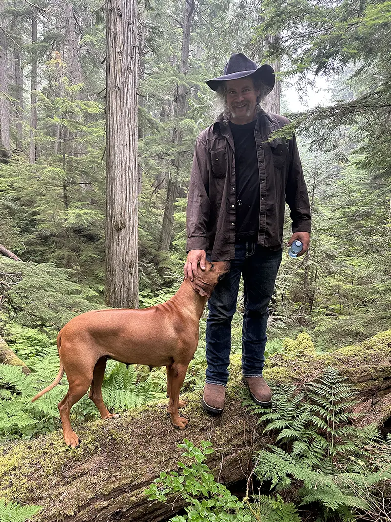 Founder Lawrence Dunkley with Jakira, his dog, in an old-growth forest in the Cariboo